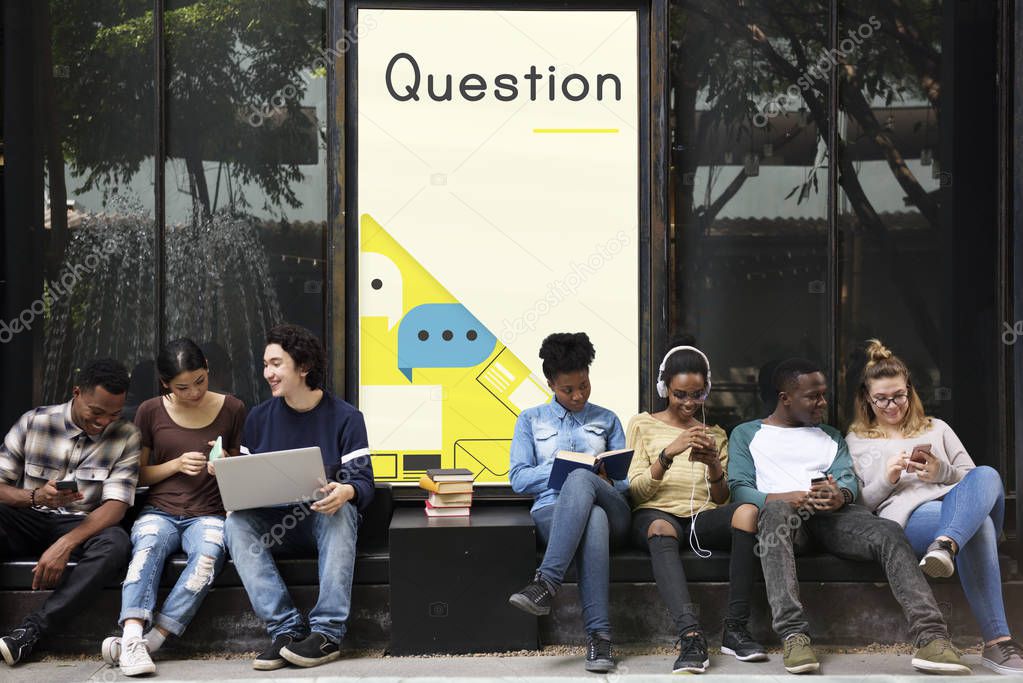 Group of multiethnic students siting outdoor and using gadgets, title on wall: Question
