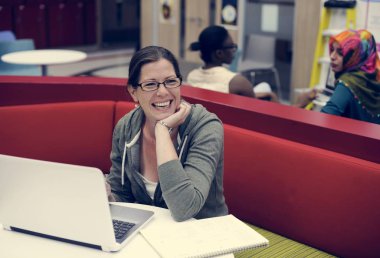 dizüstü bilgisayar kullanan mutlu gülümseyen kadın