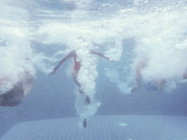 People jumping in swimming pool — Stock Photo, Image