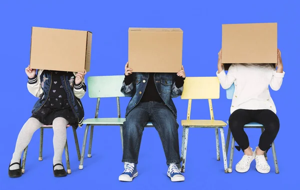 Kinderen met dozen op hoofd — Stockfoto