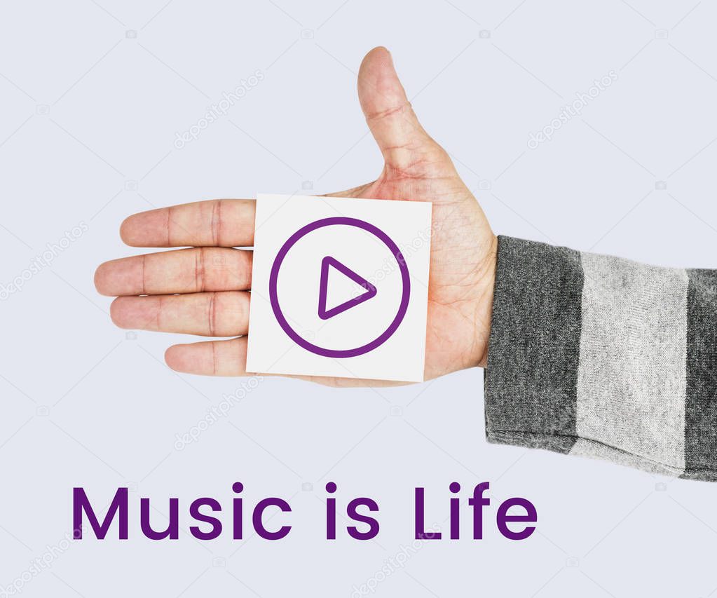 Cropped picture of male hand showing paper note with play button icon near inscription: Music Is Life