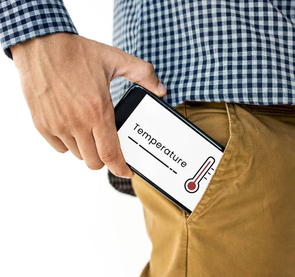 Mano poner el teléfono en el bolsillo — Foto de Stock