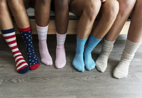 Four pairs of legs with socks — Stock Photo, Image