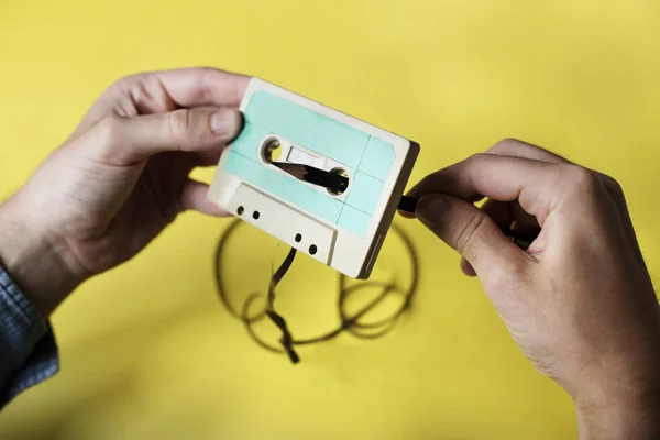Hands Holding Tape Cassette Rolling Back — Stock Photo, Image