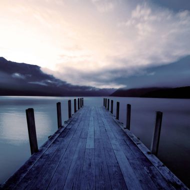 Boat jetty and a calm lake at sunrise, New Zealand, original photoset clipart