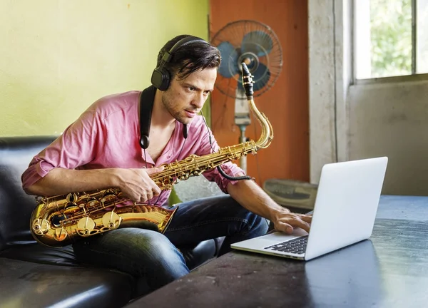 Musician holding Saxophone — Stock Photo, Image