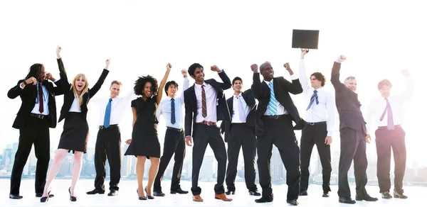 Business people with raised arms — Stock Photo, Image