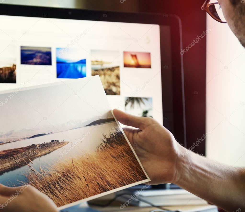 A man editing photos on a computer, original photoset