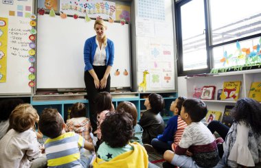 öğretmen ilköğretim okulunda eğitim kavramı dinlerken çocuklar