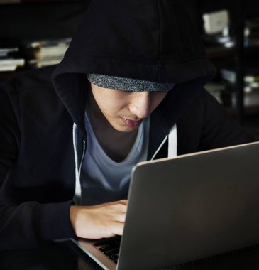 Genç adam, dizüstü bilgisayar kullanarak bir hoodie orijinal photoset