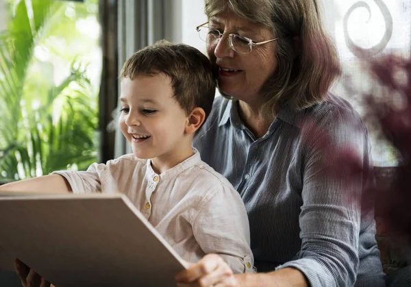 Grandmother and grandson reading book — Stock Photo, Image
