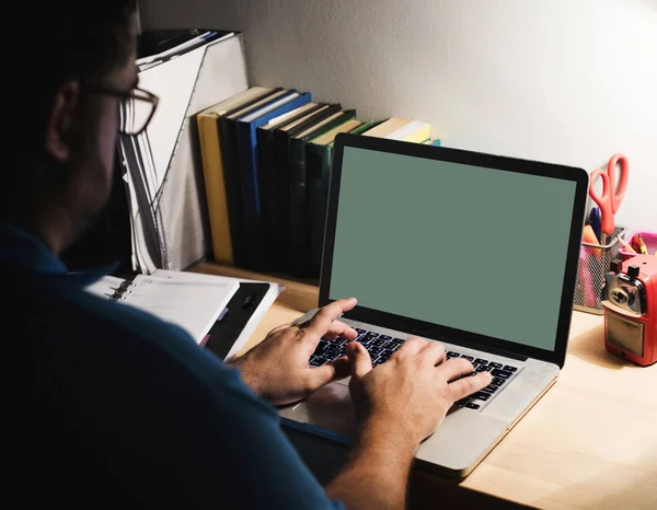 Man working in a home office with a laptop, original photoset