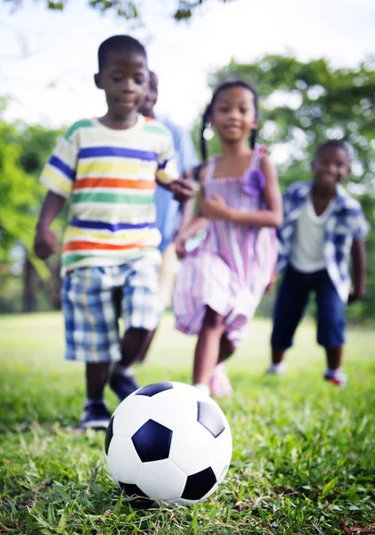 Father playing in football with kids — Stock Photo, Image