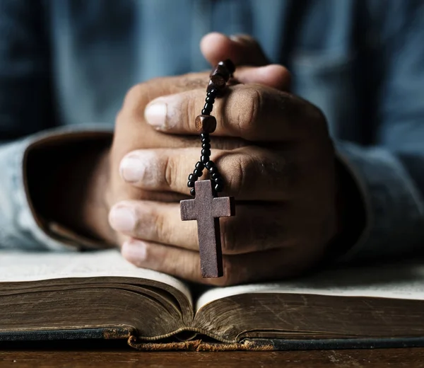 Person praying with bible book — Stock Photo, Image