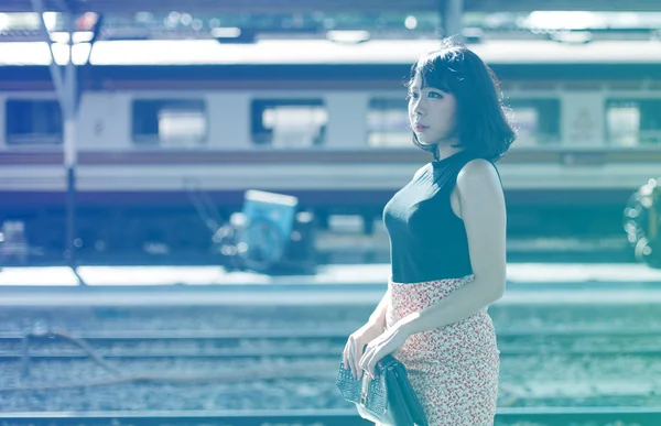 Beautiful Asian woman at railway station — Stock Photo, Image