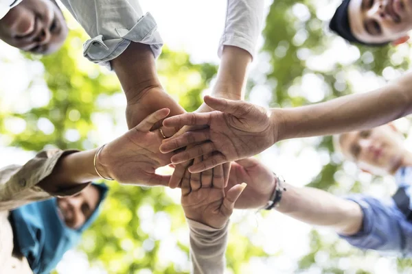 Group of diverse youth with teamwork joined hands, original photoset