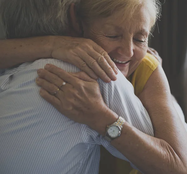 Senior couple embracing indoors — Stock Photo, Image