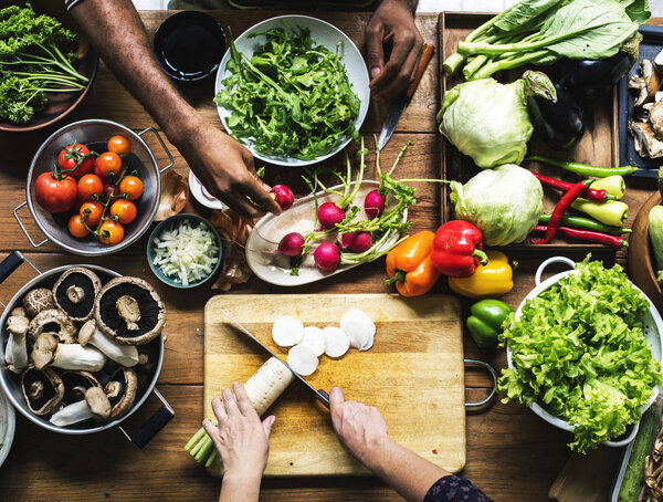 People prepare a fresh vegetable