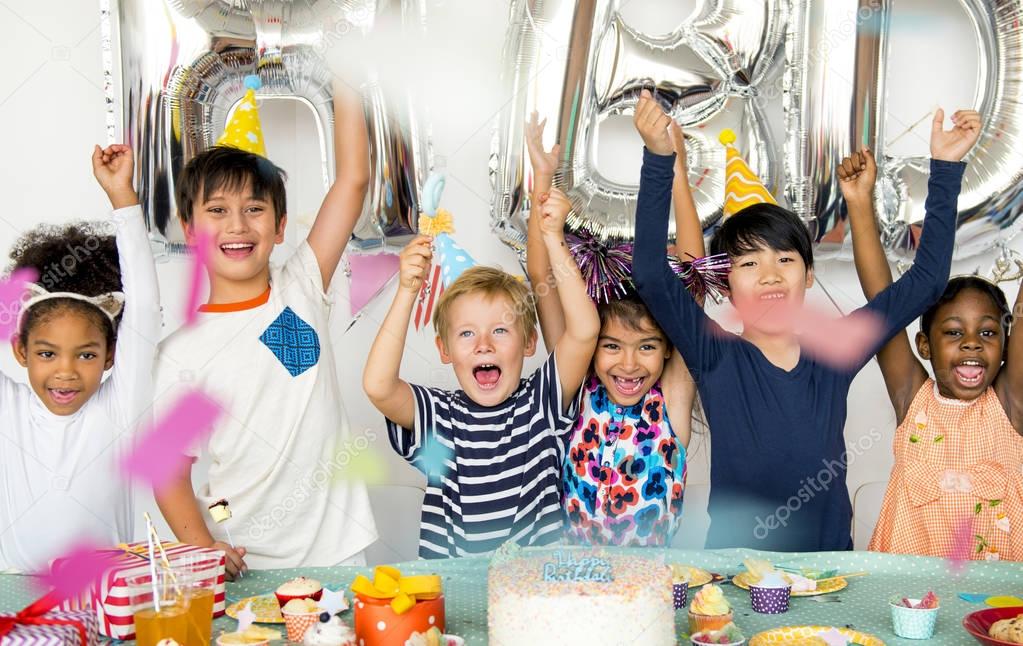 diverse group of happy children having birthday party