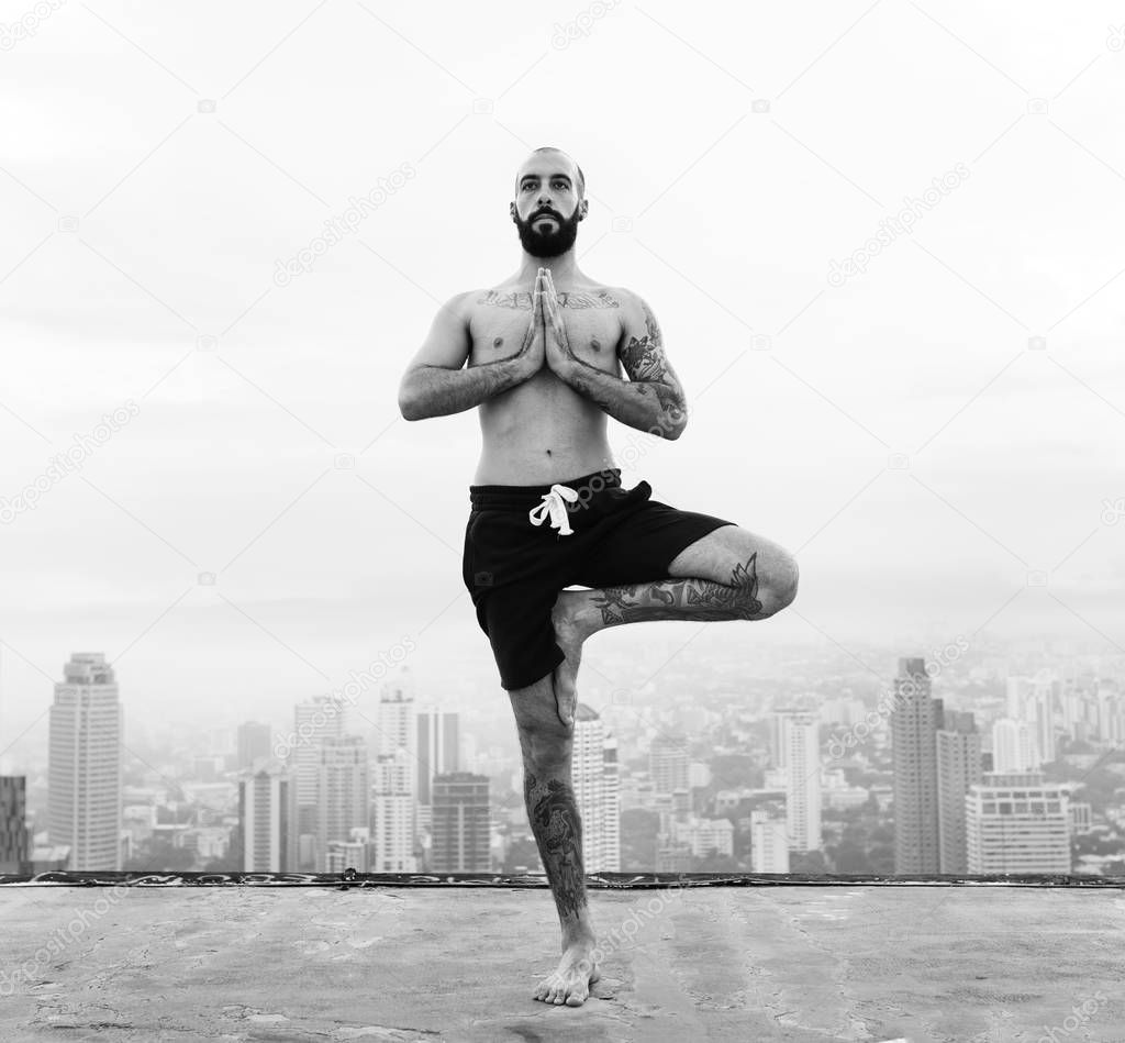 Man practicing yoga on rooftop