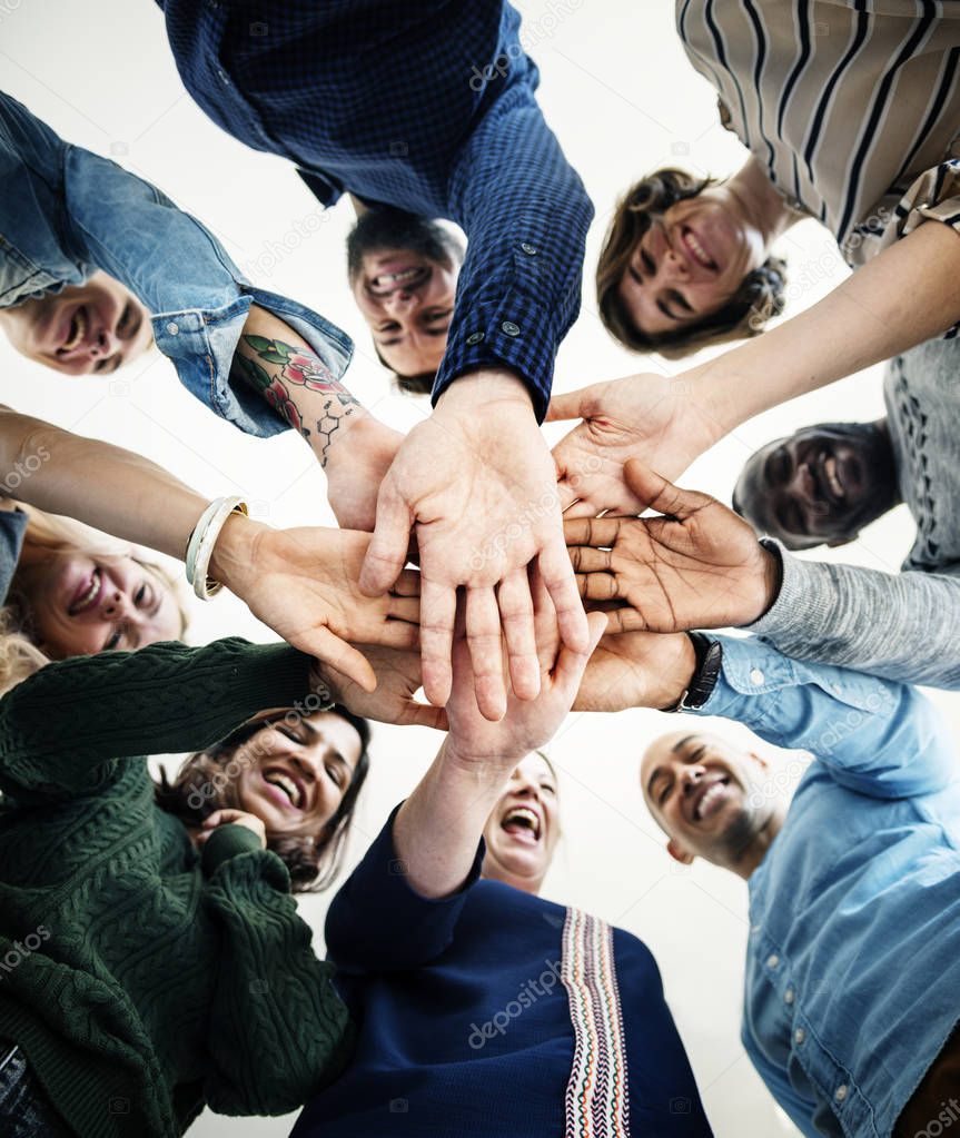 bottom view of diverse group of people holding hands together