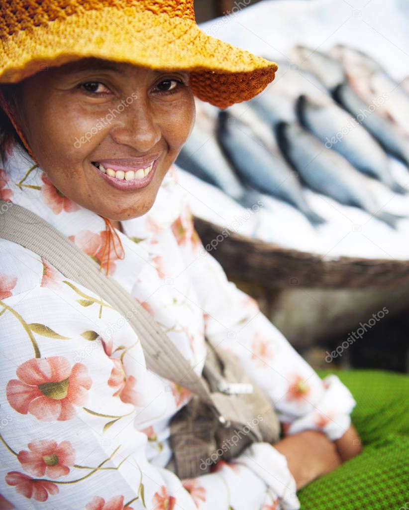 Indigenous Cambodian woman selling fish at a market, original photoset