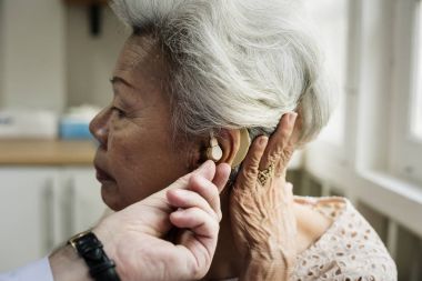 An elderly woman with hearing aid, original photoset clipart