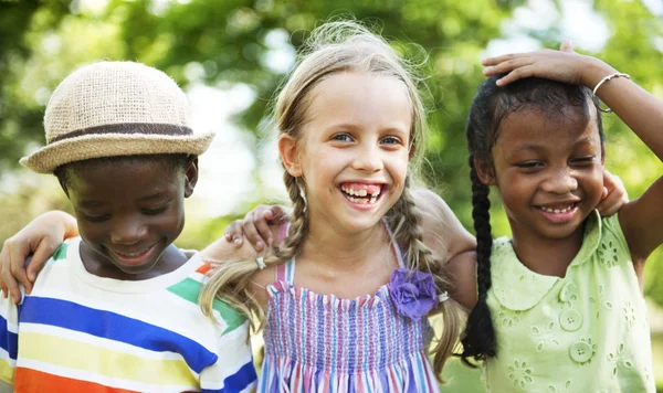 Cute diverse kids playing in the park — Stock Photo, Image