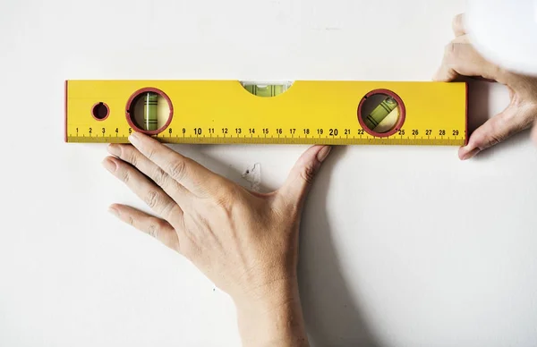 Repairman working with measuring ruler on the wall, original photoset