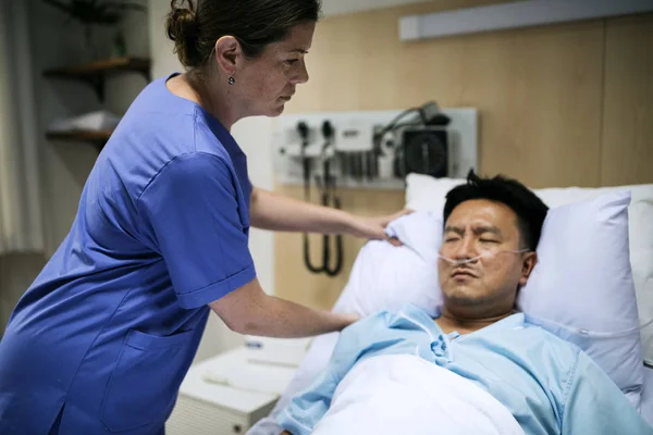 A sick Asian man in a hospital, original photoset