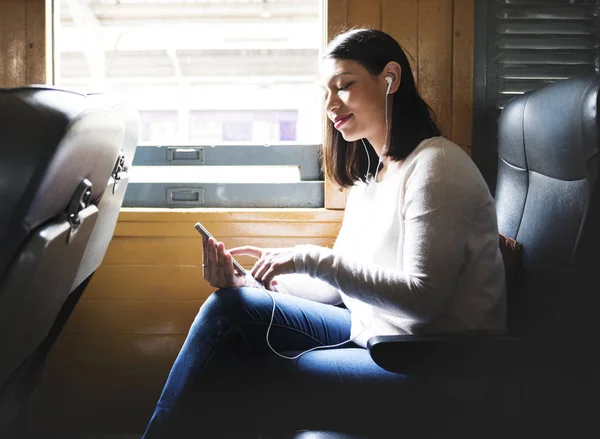 Asian woman riding train — Stock Photo, Image