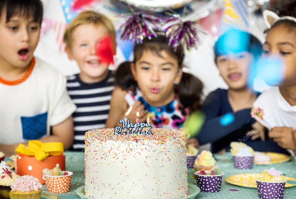 selective focus of diverse group of children having birthday party