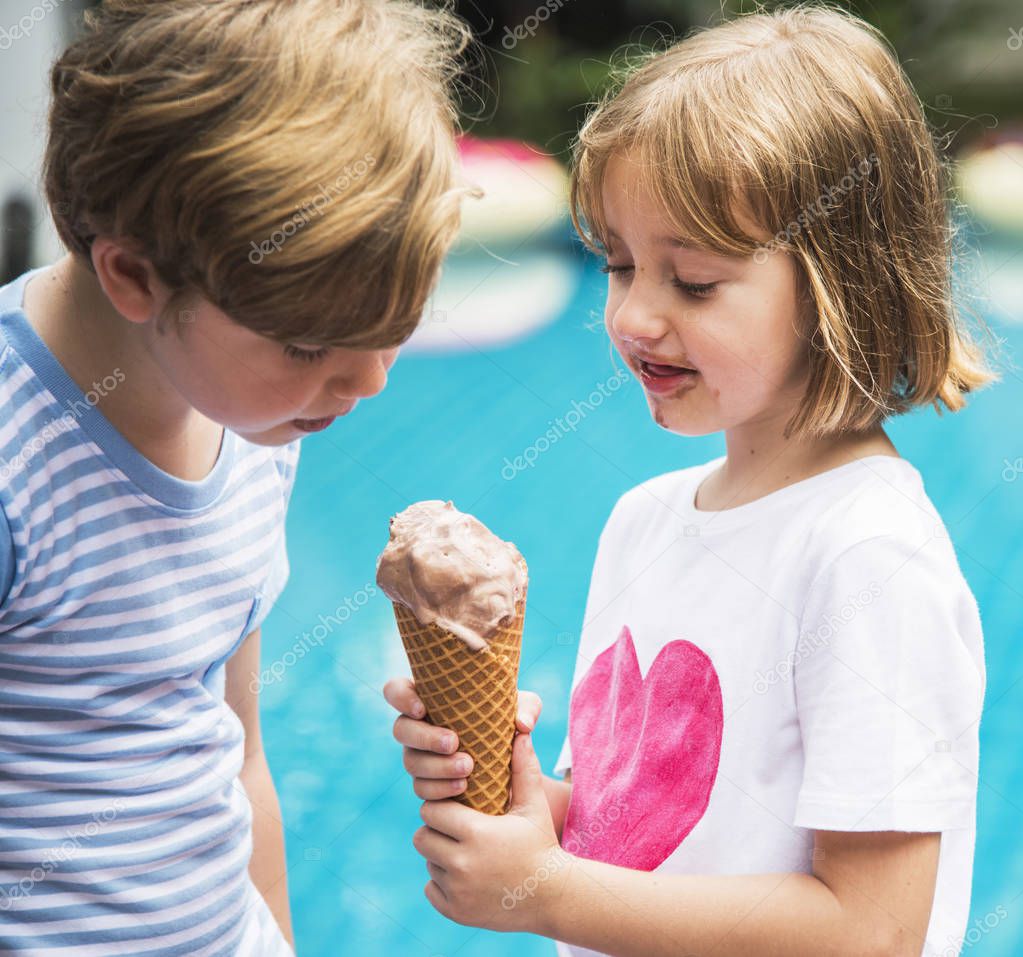 Closeup of young caucasian sibling sharing ice cream together, original photoset