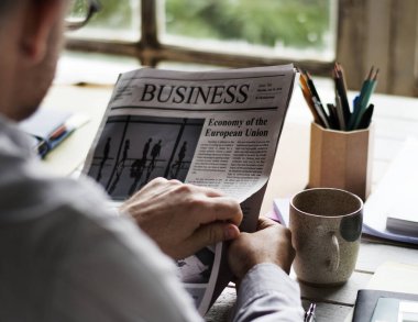 Adam bir gazete Kupası kahve, orijinal ile yakınındaki photoset okuma