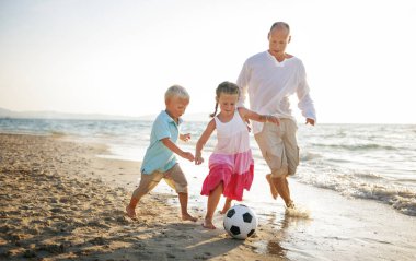 Kavramı, özgün photoset kumsalda futbol oynayan çocuklar ile beyaz baba
