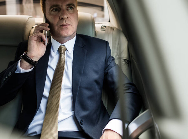 Businessman in suit talking on mobile phone, original photoset  