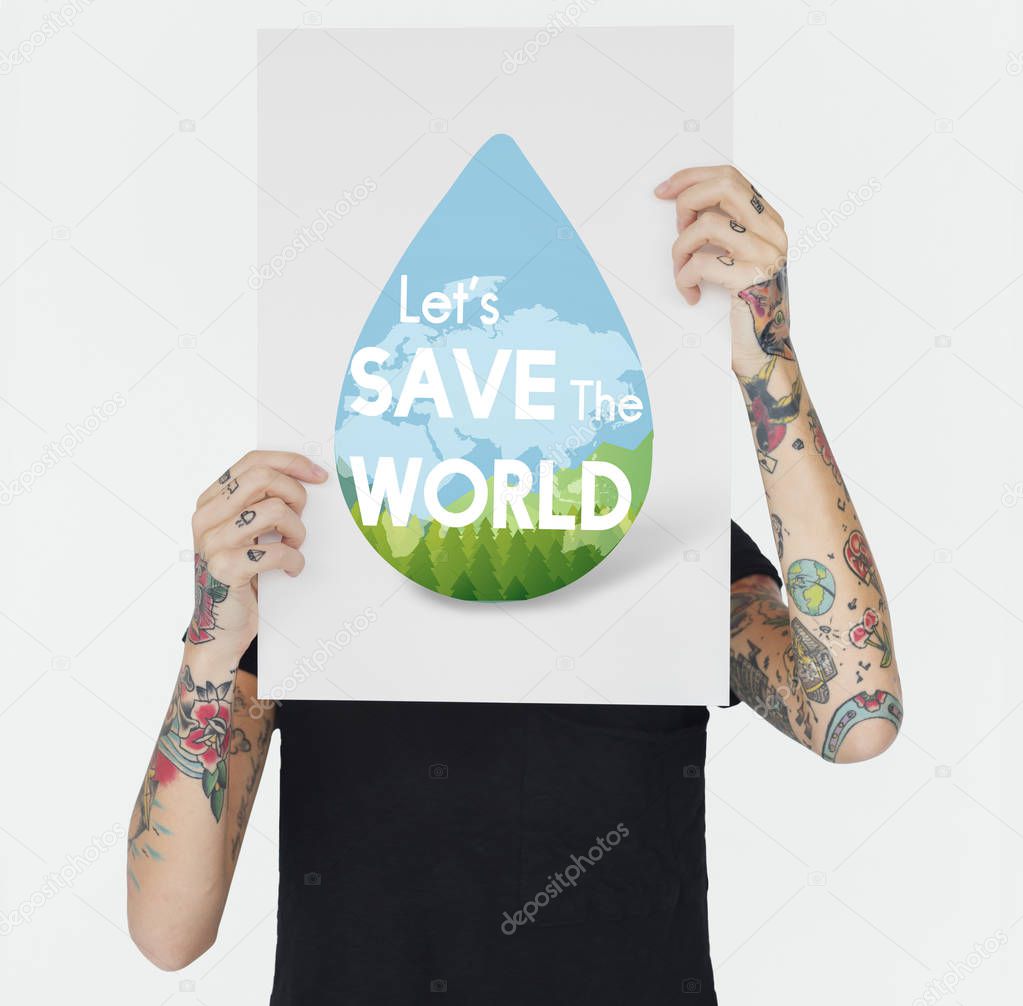 woman with tattoos on hands holding placard and covering face, text on banner: save world