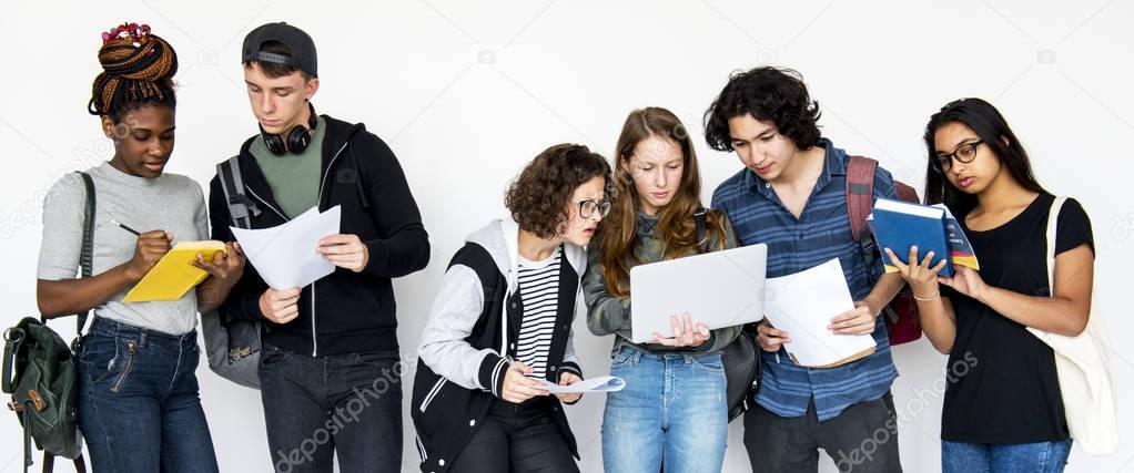 diverse group of teenagers studying together isolated on white