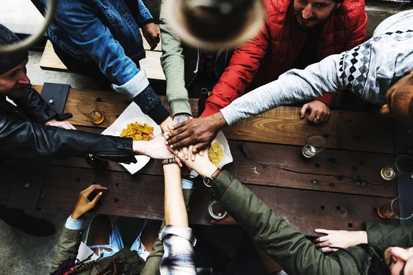 Group of diversity people in pub and hands together, original photoset