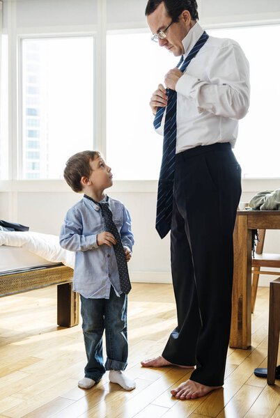 Father teaching son how to tie a tie, original photoset