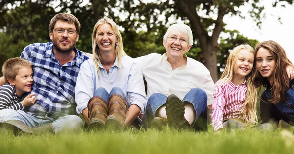 Family Generations Sitting on Grass