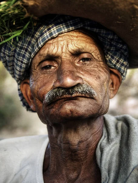 Indigenous senior Indian man looking grumpy at the camera, original photoset