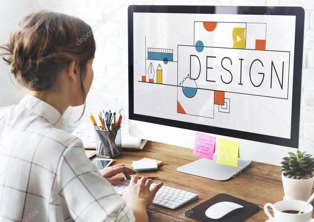 Designer woman at work, table with computer monitor, screen with title: design