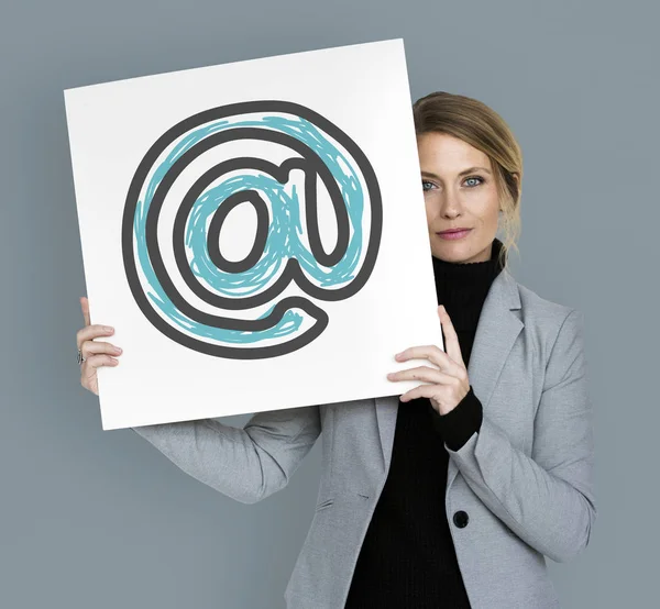 Businesswoman holding placard with at — Stock Photo, Image