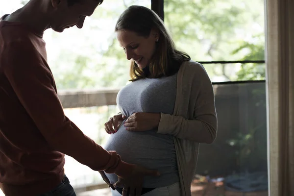 man touches belly of a pregnant woman, original photoset