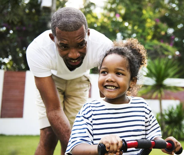 African descent father teaching daughter ride the bike, original photoset