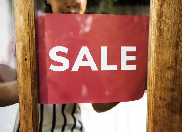 İnsanlar ahşap kapı satışı işareti koyun — Stok fotoğraf