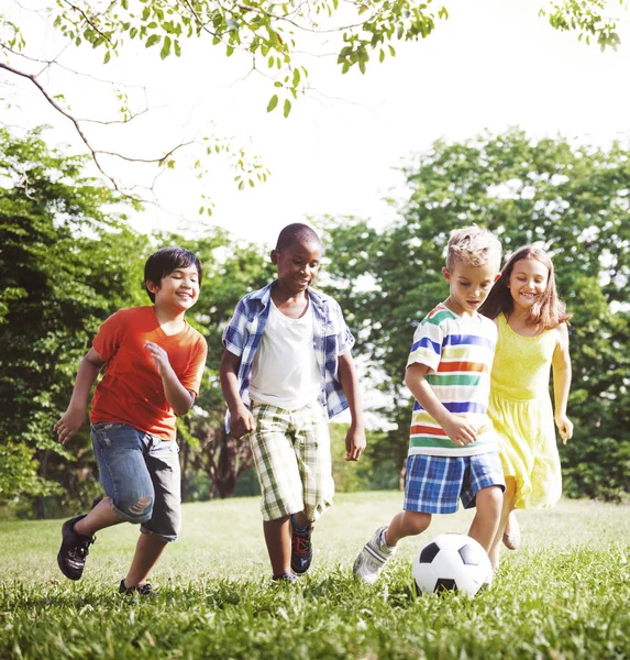 Cute diverse kids playing in the park Royalty Free Stock Images