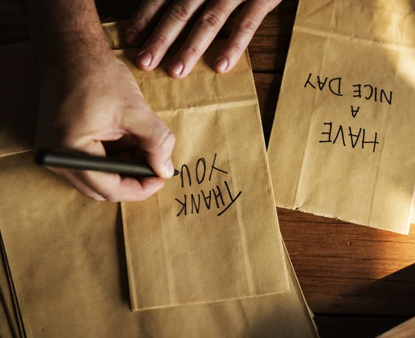 Person Hands Writing Thankful Words Paper Bag Original Photoset — Stock Photo, Image