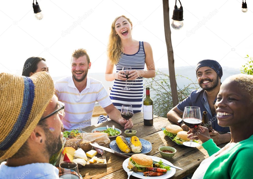 Group of diverse friends having dinner outdoors, party outdoors, original photoset